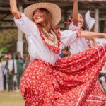 Culture Merge - A woman in a red and white dress is dancing
