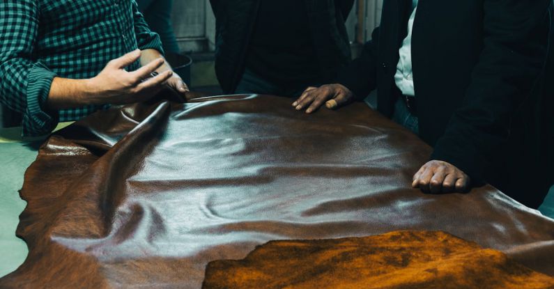 Group Table - Three men are looking at a leather table
