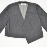 Jacket Pocket - Stylish formal jacket with button near pocket and label on white background in studio