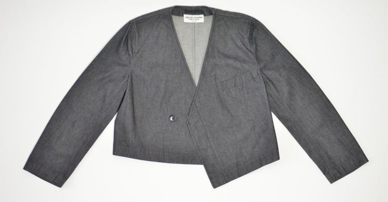 Jacket Pocket - Stylish formal jacket with button near pocket and label on white background in studio
