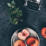 Caffeine Diet - Photo Of Sliced Peaches Beside Analog Camera
