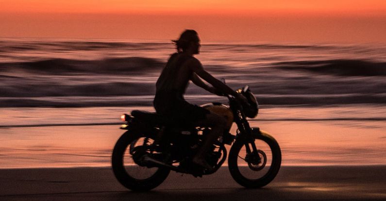 Motorcycle Sunrise - Man Riding Motorcycle on Beach during Sunset